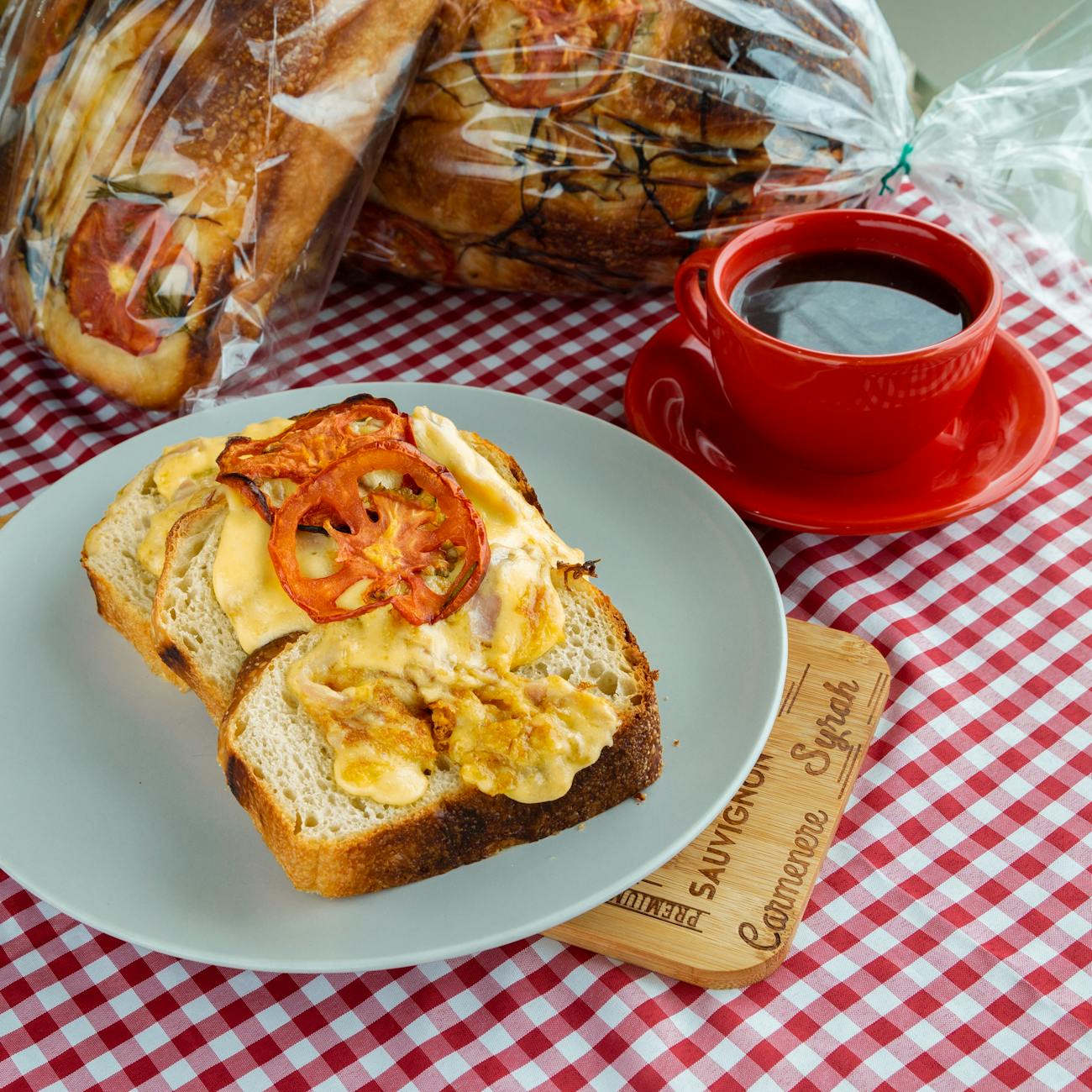 a bread with scrambled eggs near the cup of coffee on the table