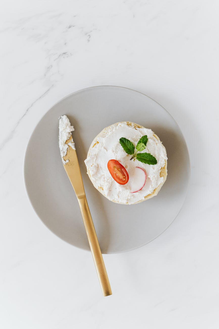 bun with cottage cheese and vegetable on platter with knife